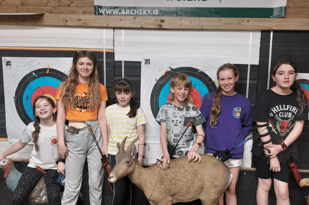 Group of youth students posing with a 3D sheep target in a training workshop