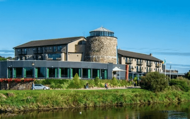Large hotel or resort complex featuring a distinctive circular stone tower wing